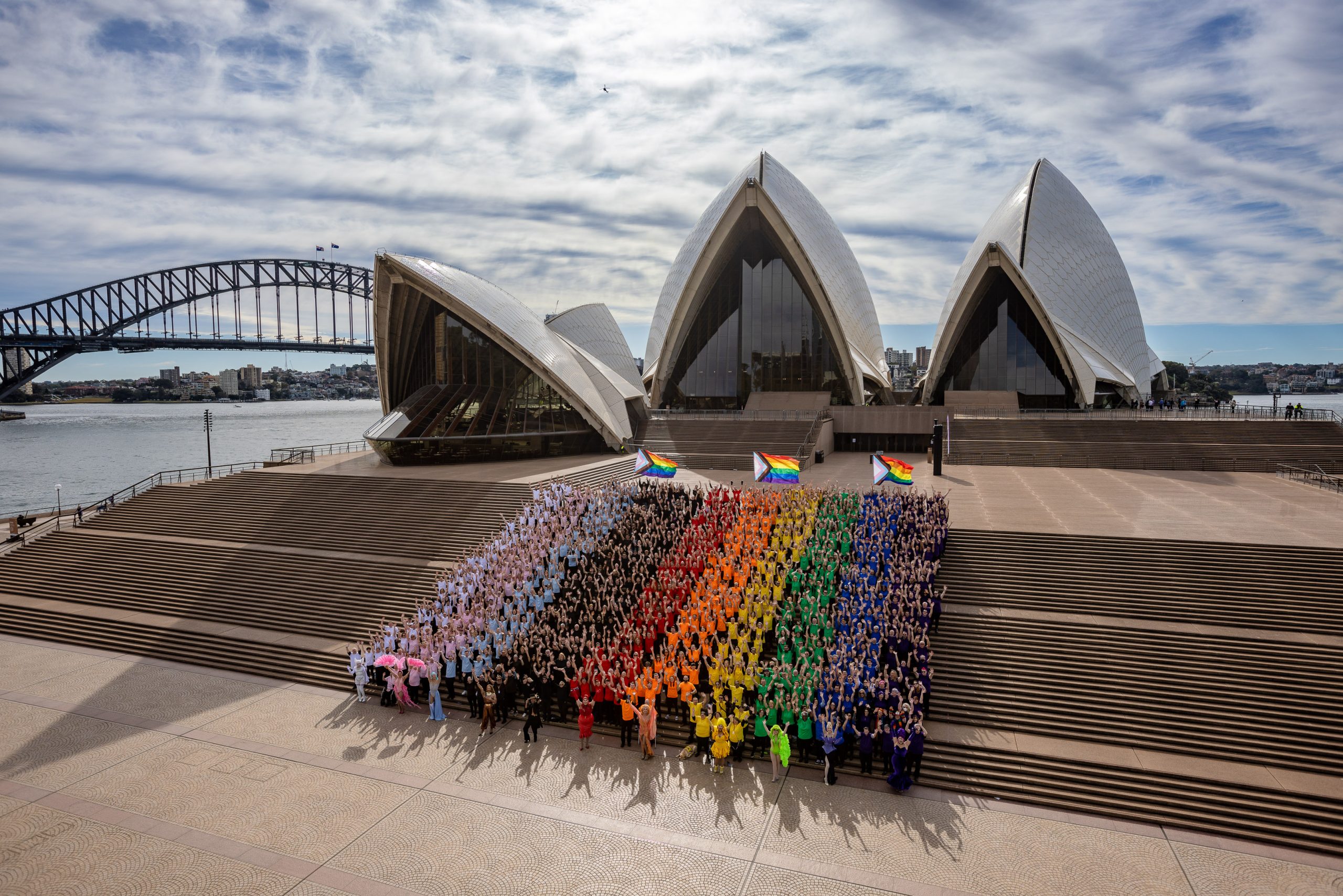 Sydney Marks the 44th anniversary of Mardi Gras by inviting the World to Sydney World Pride 2023 with human pride progress flag.